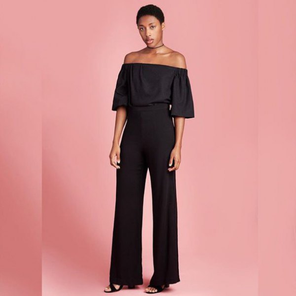 black off-the-shoulder blouse with high pants and wide legs
