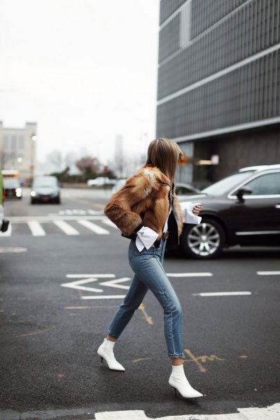 brown faux fur coat with gray skinny jeans