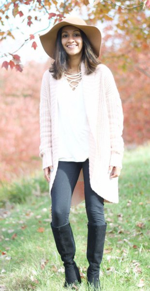 white cardigan with gray leggings and knee high boots