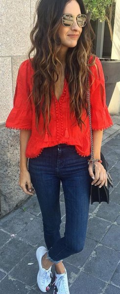red V-neck blouse and dark blue skinny jeans