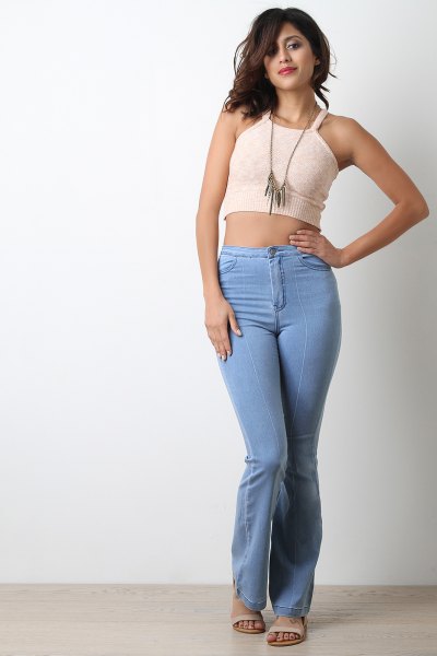 Cropped light pink vest top with light blue high-rise jeans