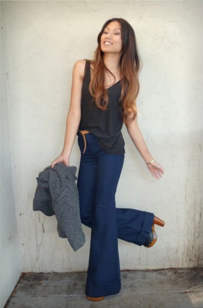 black tank top with dark blue high waisted flared jeans