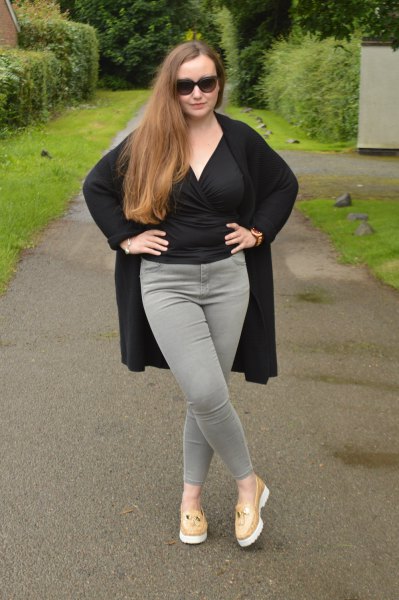 black wrap blouse with gray slim fit jeans and blush pink slippers