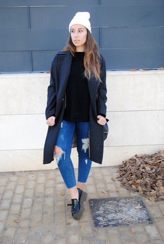 black wool coat with blue ripped slim fit jeans and leather loafers
