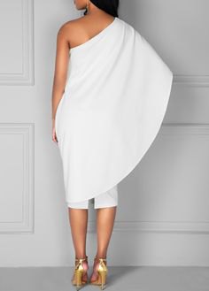 white wrap dress with one shoulder and gold heels