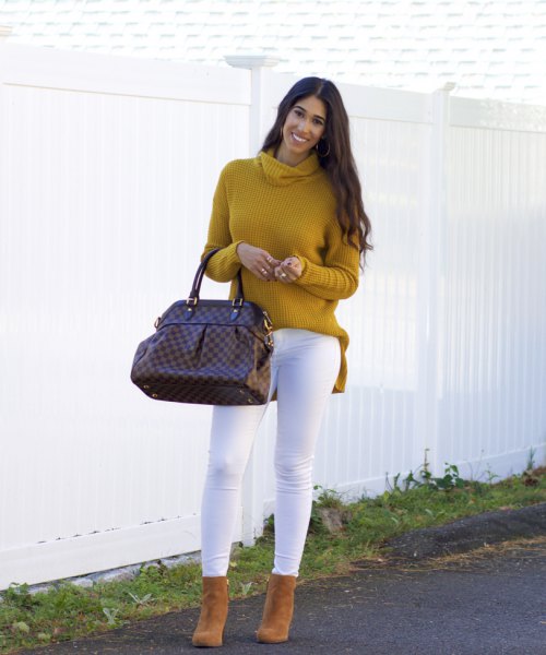 Mustard yellow ribbed cowl neck sweater and white skinny jeans