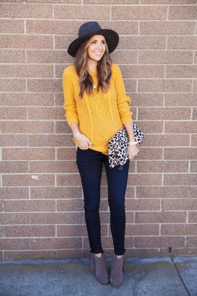Cable knit mustard jumper with black felt hat and leopard print wallet