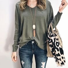 V-neck relaxed fit long sleeve top with ripped skinny jeans and a zebra print tote bag