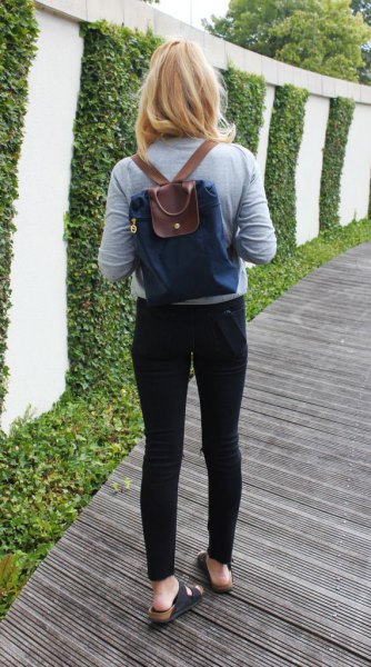 dark blue and brown backpack wallet with gray long sleeve t-shirt