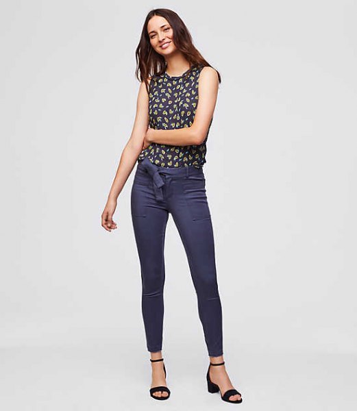 sleeveless blouse with dark blue and red print and blue chinos