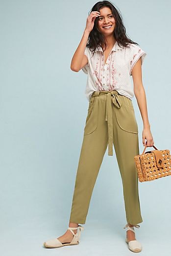 white sleeveless blouse with green cropped chinos