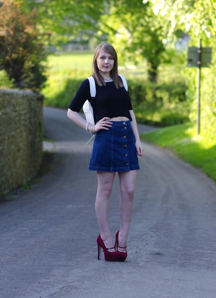 black crop top with half sleeves and a blue flared denim skirt