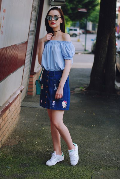 Sky blue off-the-shoulder blouse with an embroidered denim skirt with a button placket