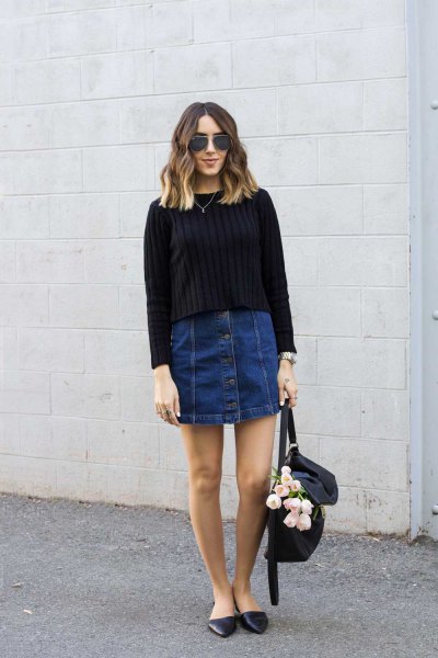 black ribbed knit sweater with dark blue denim mini skirt with button placket