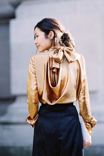 Metallic blouse with gold cowl neckline and black mini skirt