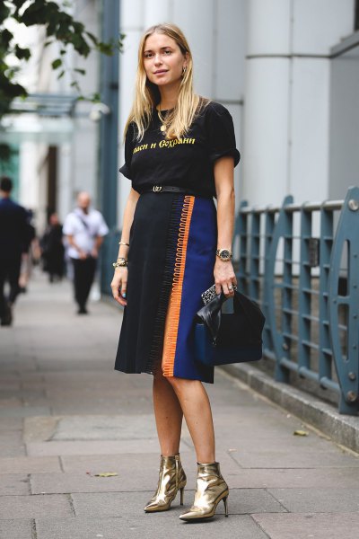 black graphic tee with high midi skirt and gold boots
