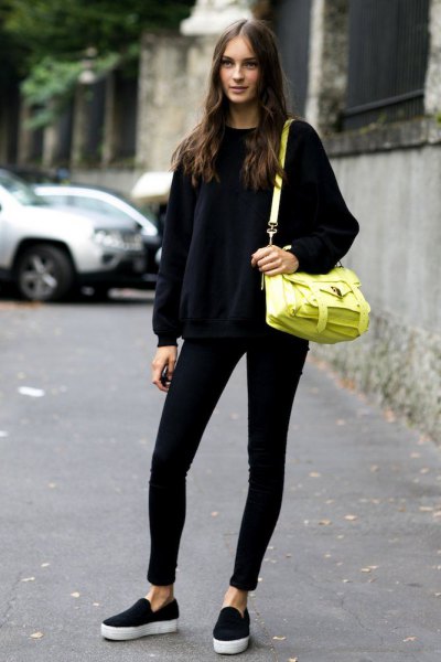black knit sweater with round neckline and lemon yellow leather shoulder bag