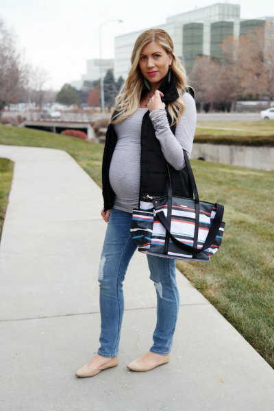 gray long sleeve t-shirt with black vest and straight leg jeans
