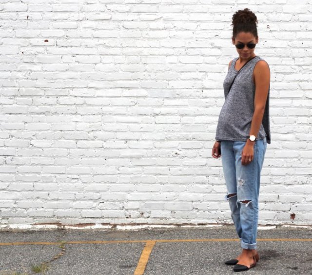 gray sleeveless scoop-neck sweater and relaxed light blue jeans