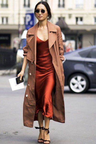 Camel maxi trench coat over burgundy silk maxi slip dress