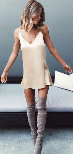 Blush pink mini slip dress with gray suede over the knee boots