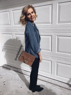 gray and blue button down shirt, black slim fit jeans and gray suede crossbody bag