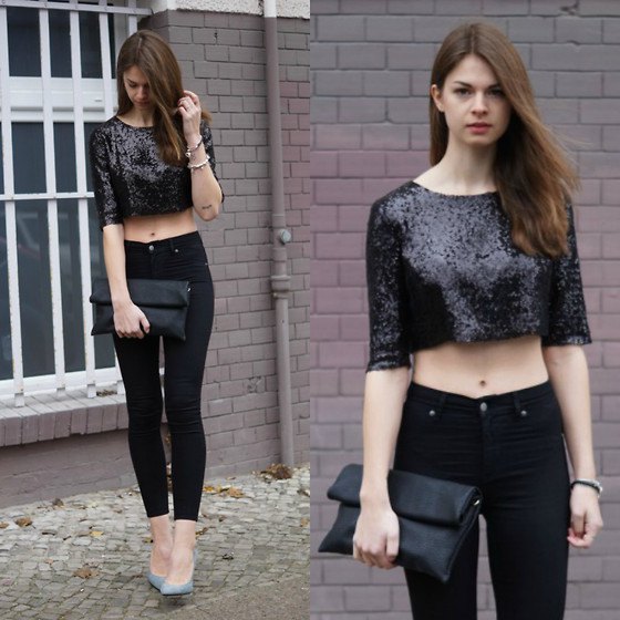 black sequin crop top with skinny jeans and leather handbag