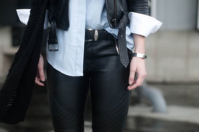 black leather jacket with white shirt and belted biker pants