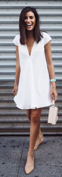 white swing dress with deep V-neckline and cap sleeves