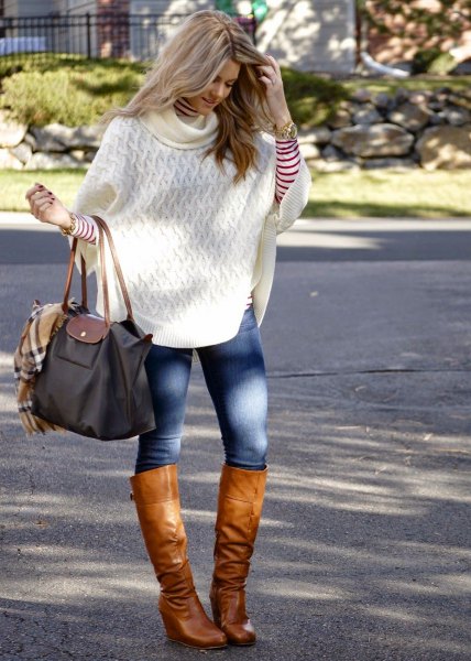 white cable pattern turtleneck poncho sweater and brown leather knee high boots