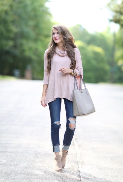 Light pink ribbed poncho sweater with ribbed cuffed jeans