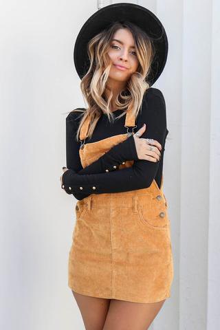 black sweater with camel dress and felt hat