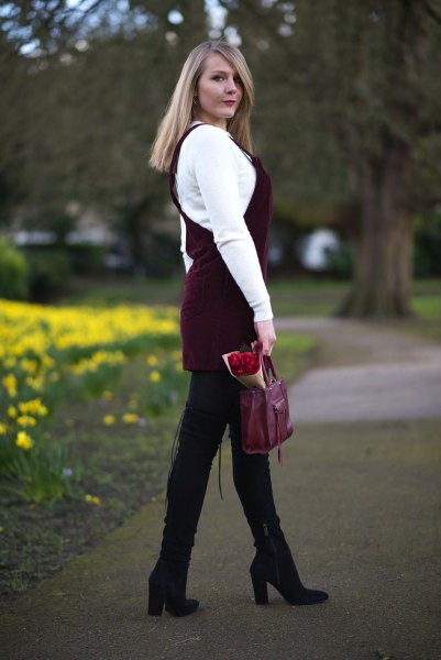 white sweater with black corduroy dress and black high-heeled boots