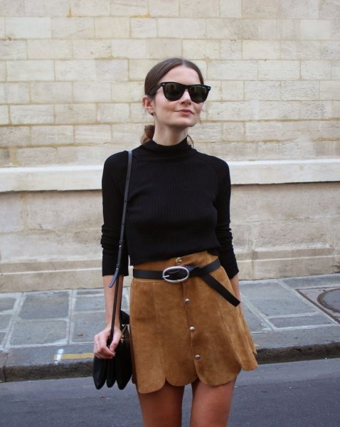 black sweater with brown mini skirt with scalloped hem and belt