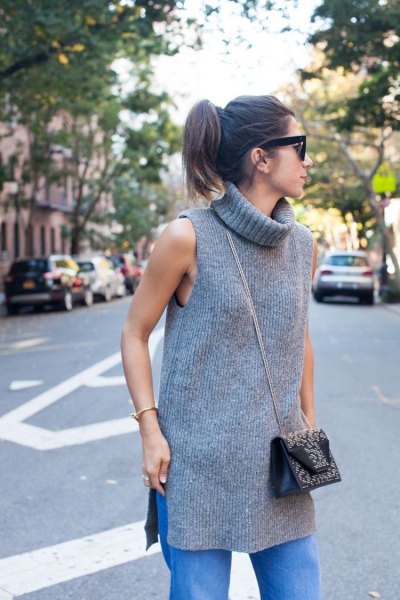 gray sleeveless ribbed tunic with turtleneck and blue straight-leg jeans