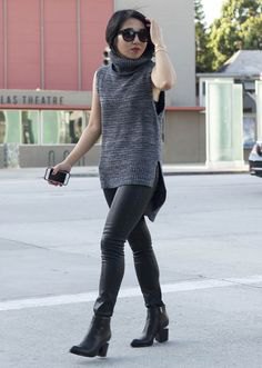gray sleeveless gray sweater with black leather leggings