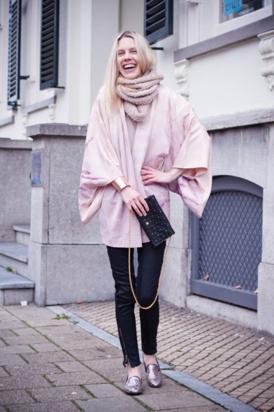 Light pink chunky cardigan with black leather pants and gold metallic slippers