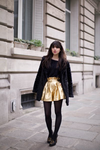 golden flowing shorts with a black teddy coat