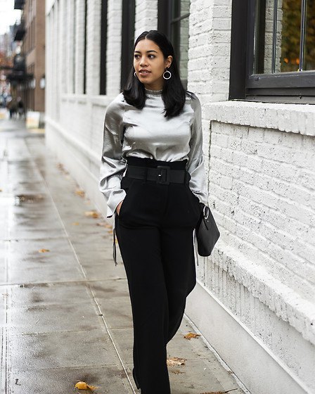 silver metallic blouse with black pants with high waist and wide legs
