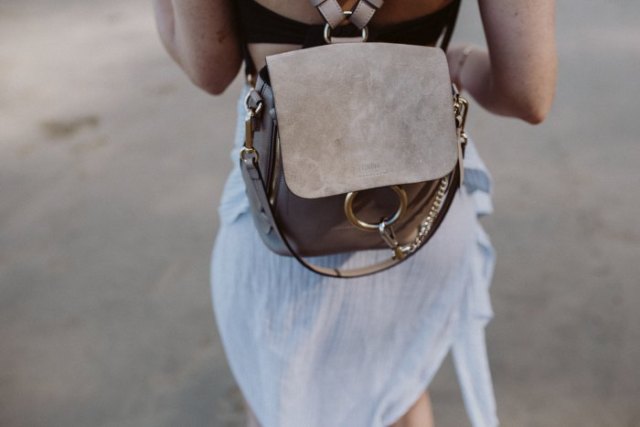 Airy white chiffon mini dress with gray suede backpack handbag