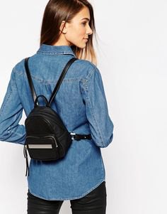 blue button down chambray shirt and black small backpack wallet