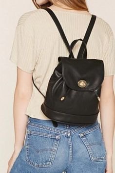 Light pink ribbed top with black leather, small backpack and jeans