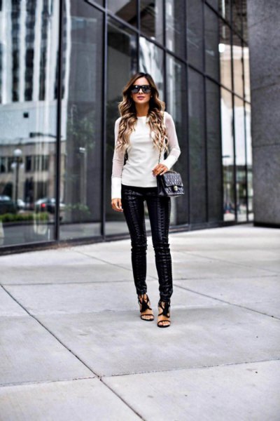 White long-sleeved form-fitting sweater with leather leggings and open toe heels