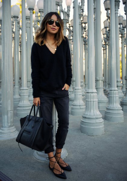 black chunky v-neck sweater, slim-fit jeans and strappy velvet flats
