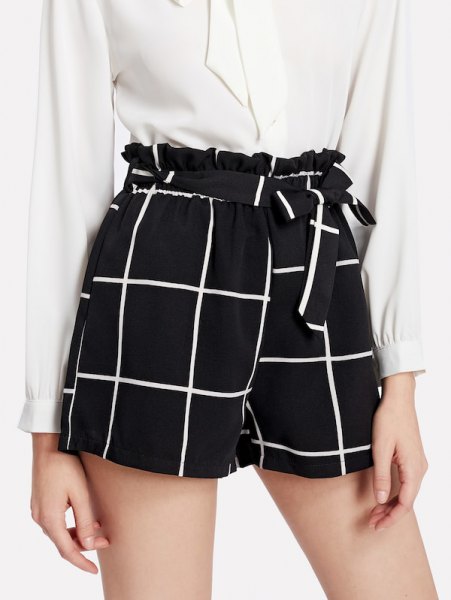 white button down blouse and black plaid shorts