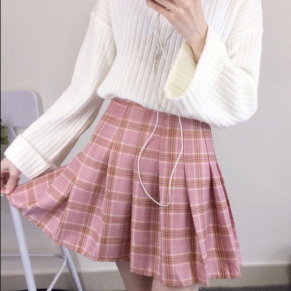 White ribbed knit sweater with red pleated plaid mini skirt
