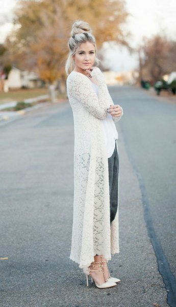white maxi crochet sweater cardigan with black cropped pants