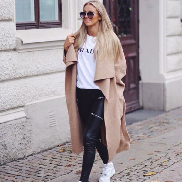 Camel taxi length winter coat with white printed t-shirt and black leather pants