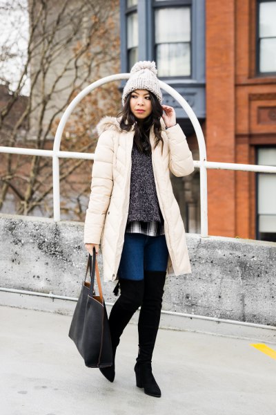 long white down coat with a mottled gray sweater and overknee boots