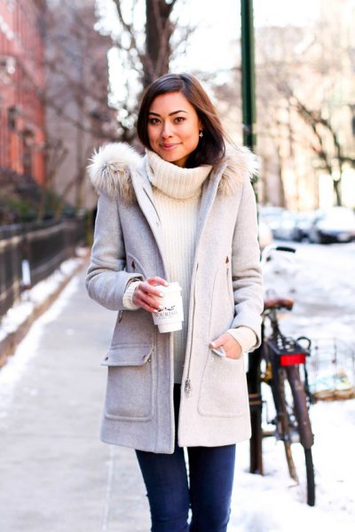 light gray long winter coat with white turtleneck sweater